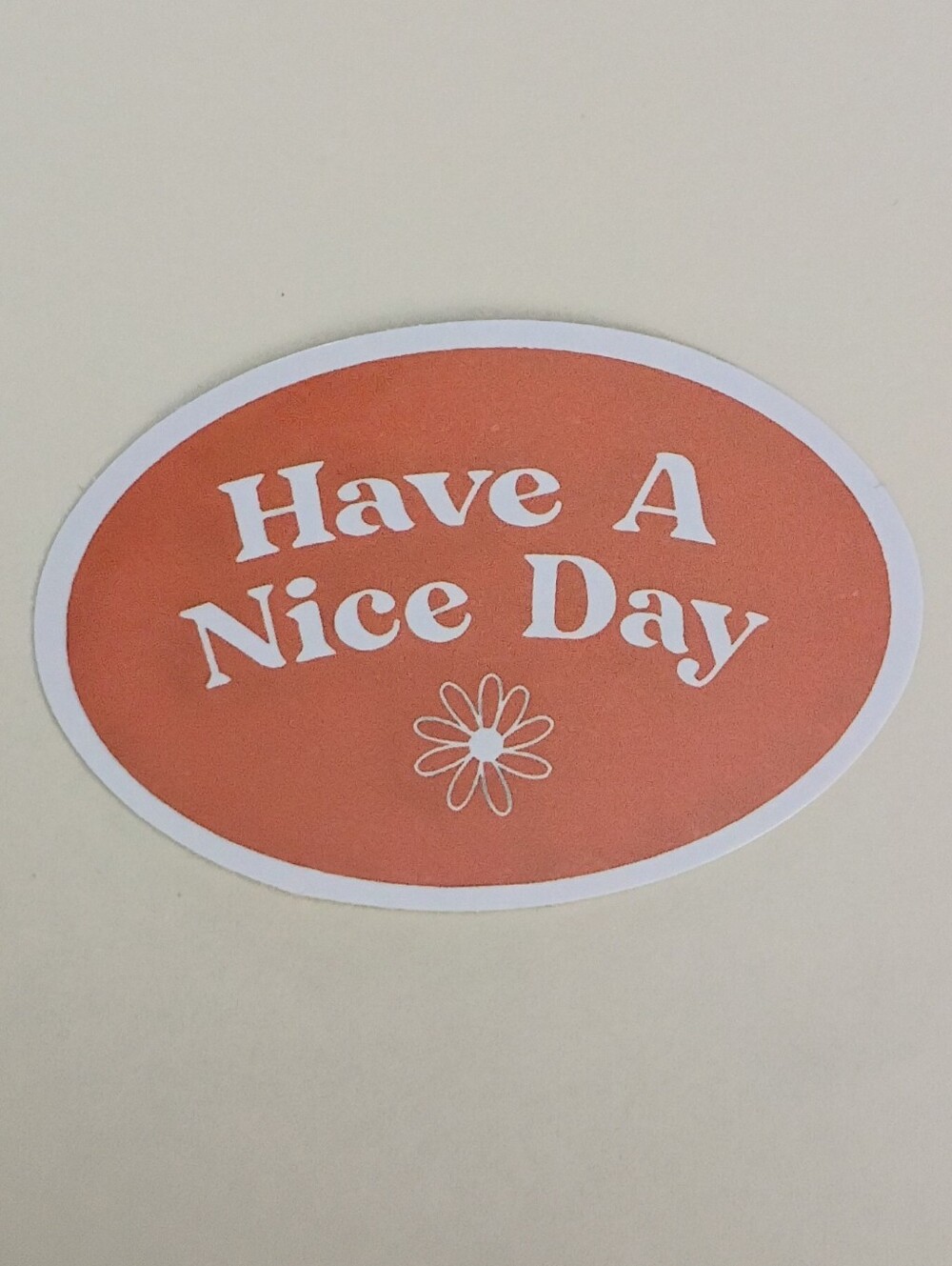 10/$10 Sticker - Have A Nice Day - Orange Oval Background w/ White Text & Flower